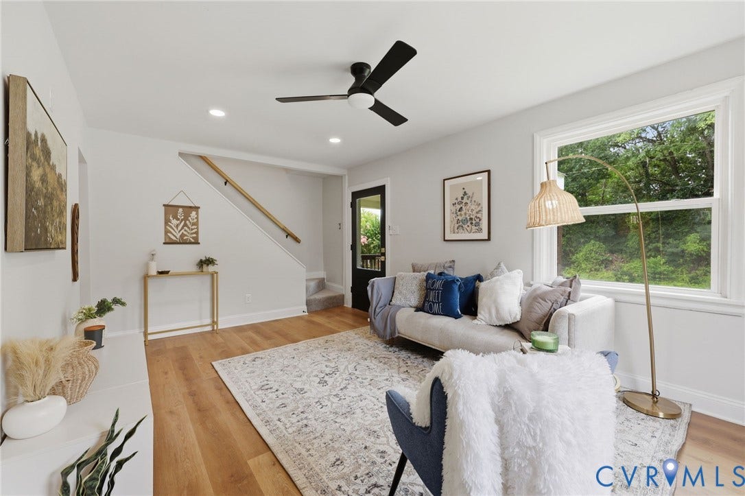 Recessed lighting, wood-finish flooring, a contemporary ceiling fan, and a prominent window