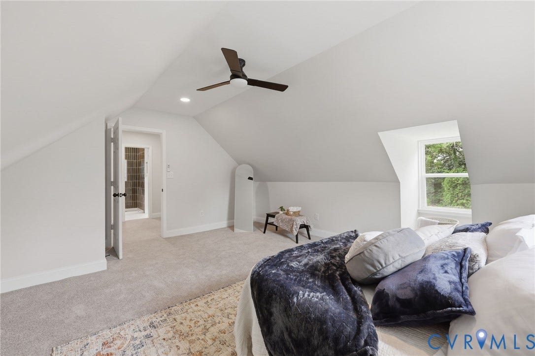 Carpeted room with a ceiling fan, recessed lighting, and an egress window