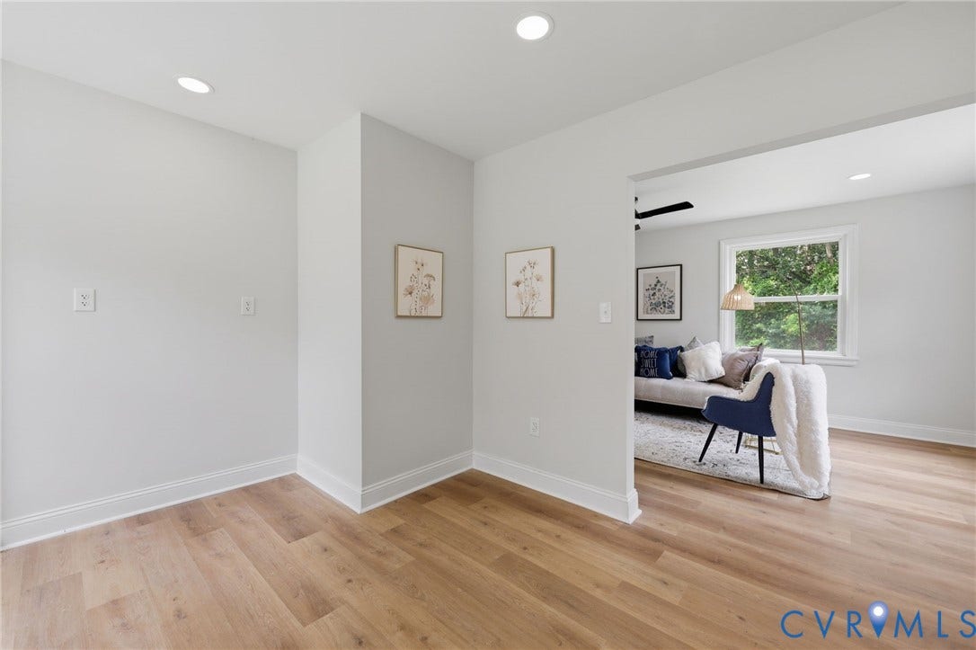 Recessed lighting, light wood-finish flooring, and white trim
