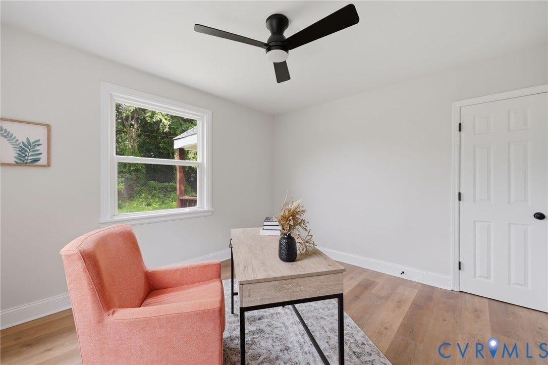 Ceiling fan with integrated lighting, wood-finish flooring, white trim, single window, and a paneled door with dark hardware