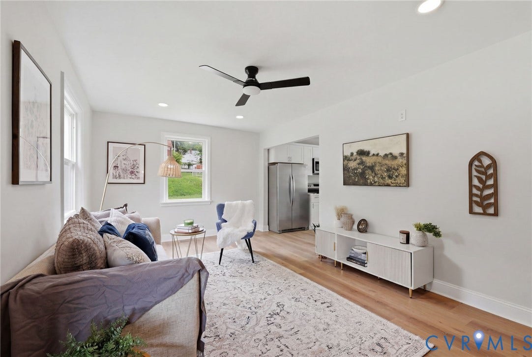 Recessed lighting, wood-finish flooring, white walls, black ceiling fan, and multiple windows