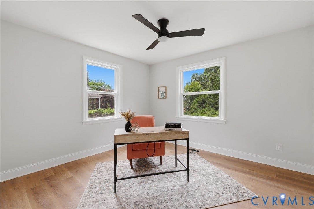 Wood-finish flooring, white walls, and a ceiling fan with integrated lighting
