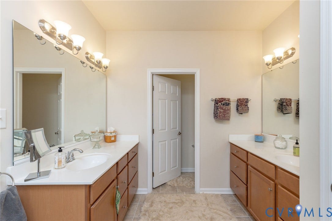 Dual vanity with integrated sinks and wood-finish cabinetry