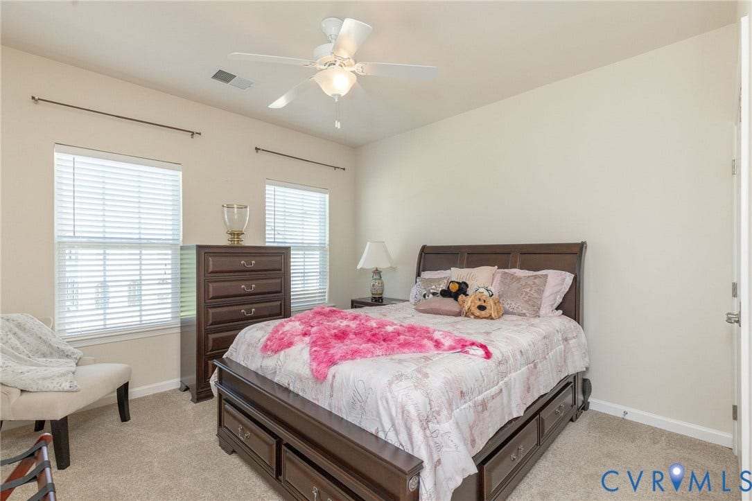 Two windows with blinds, ceiling fan with integrated lighting, and neutral wall paint