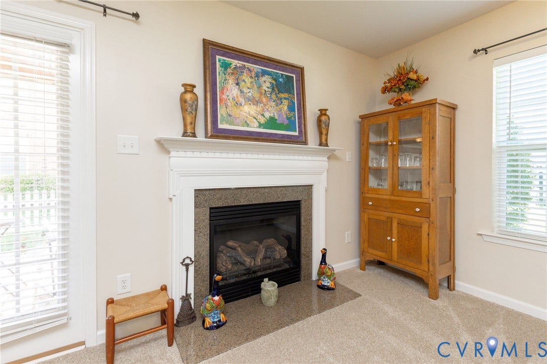 Gas fireplace with a white mantel and stone surround