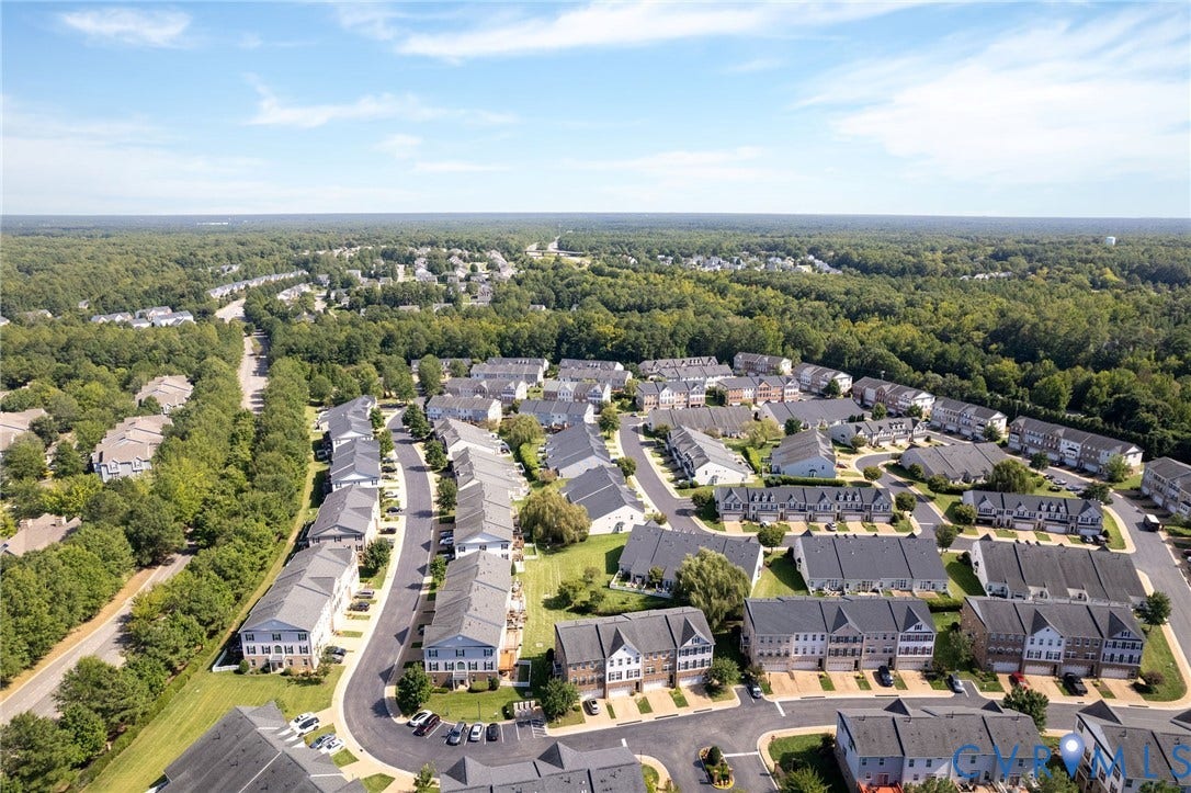 Residential community with varied roofing styles and mature tree coverage