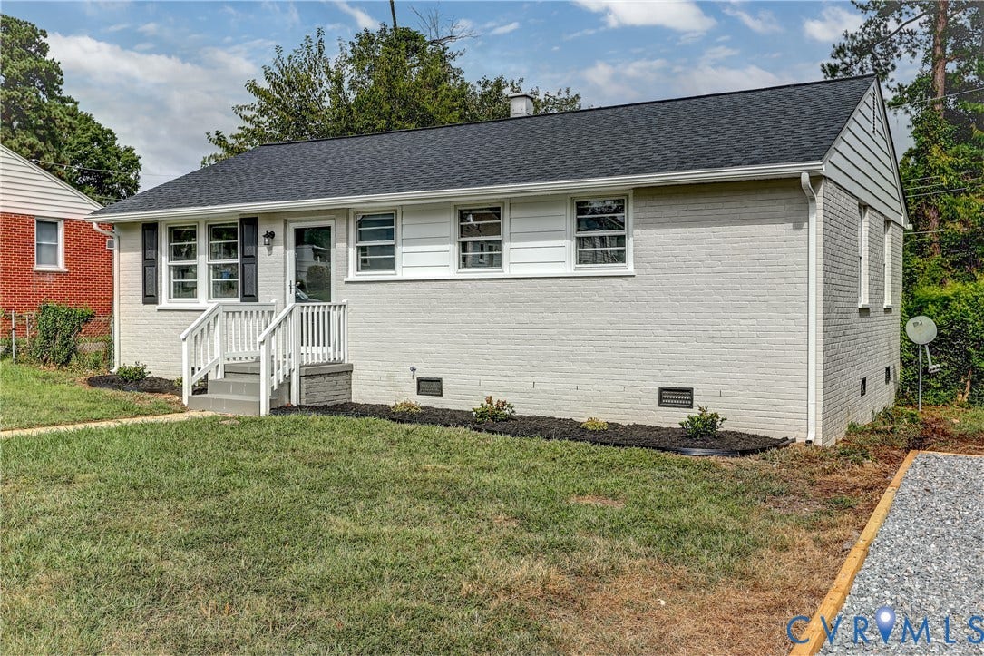 Brick exterior with a freshly laid gravel driveway.  SO CHARMING!