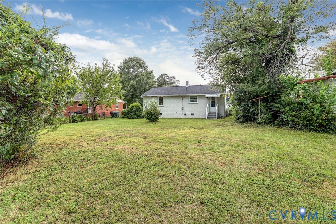Expansive rear yard with natural landscaping and mature trees!!