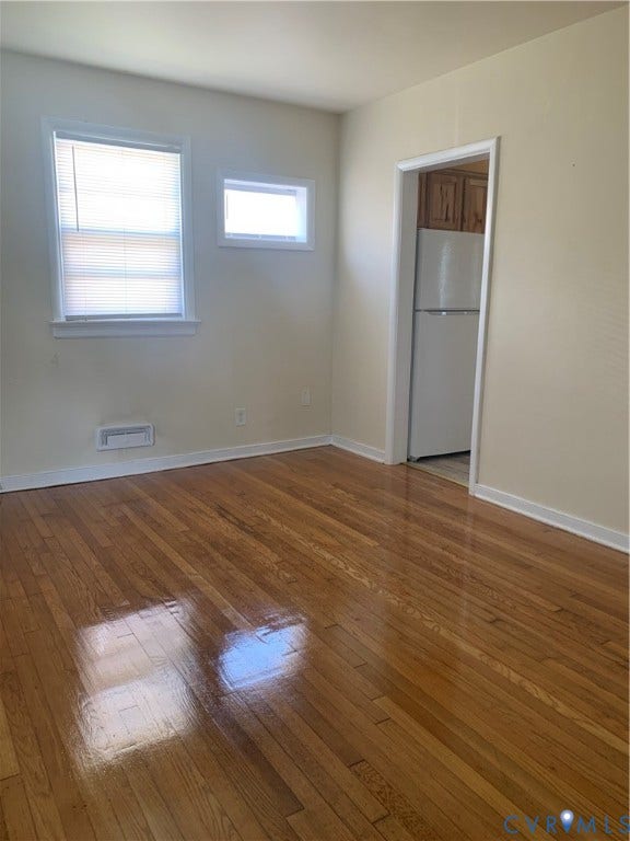 Wood-finish flooring throughout, paired with a neutral wall palette