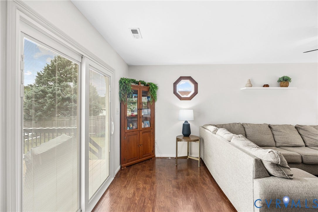 Wood-finish flooring, white walls, and a sliding glass door