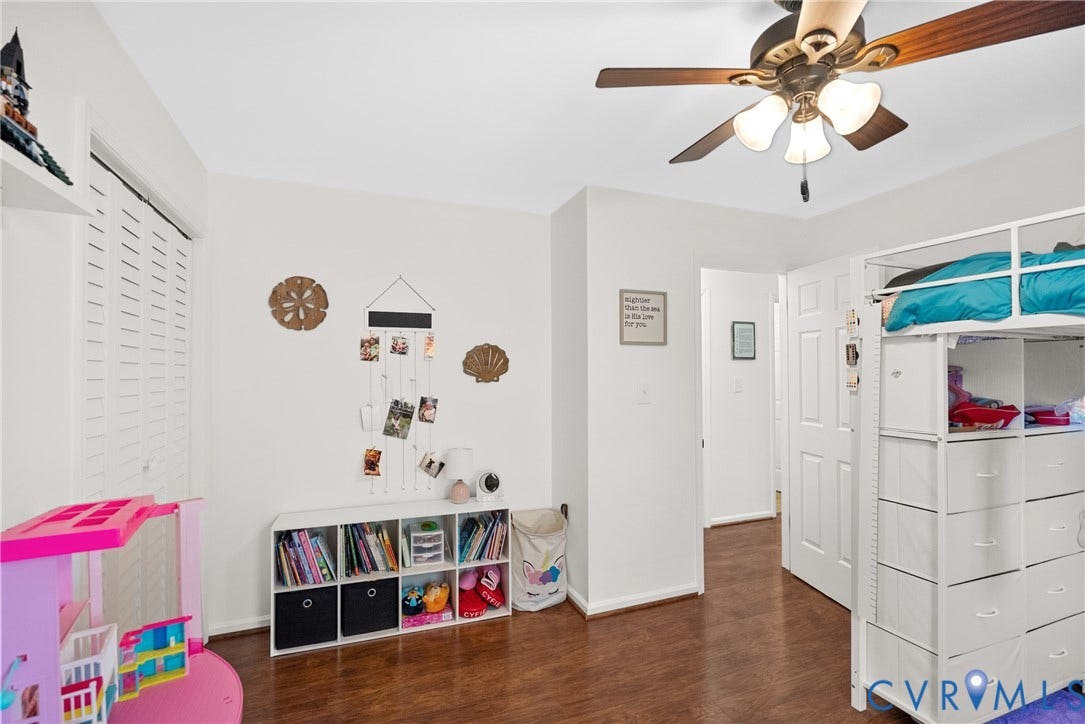 Wood-finish flooring, white walls, and a ceiling fan with integrated lighting
