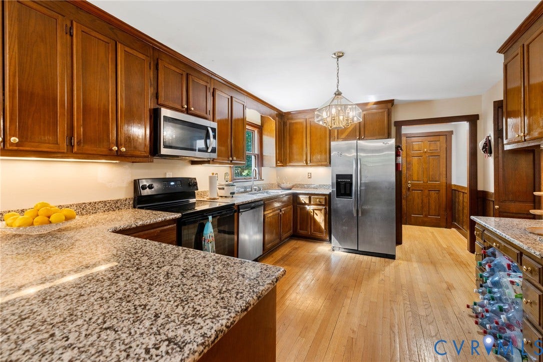 Wood-finish flooring with wood-paneled walls and trim