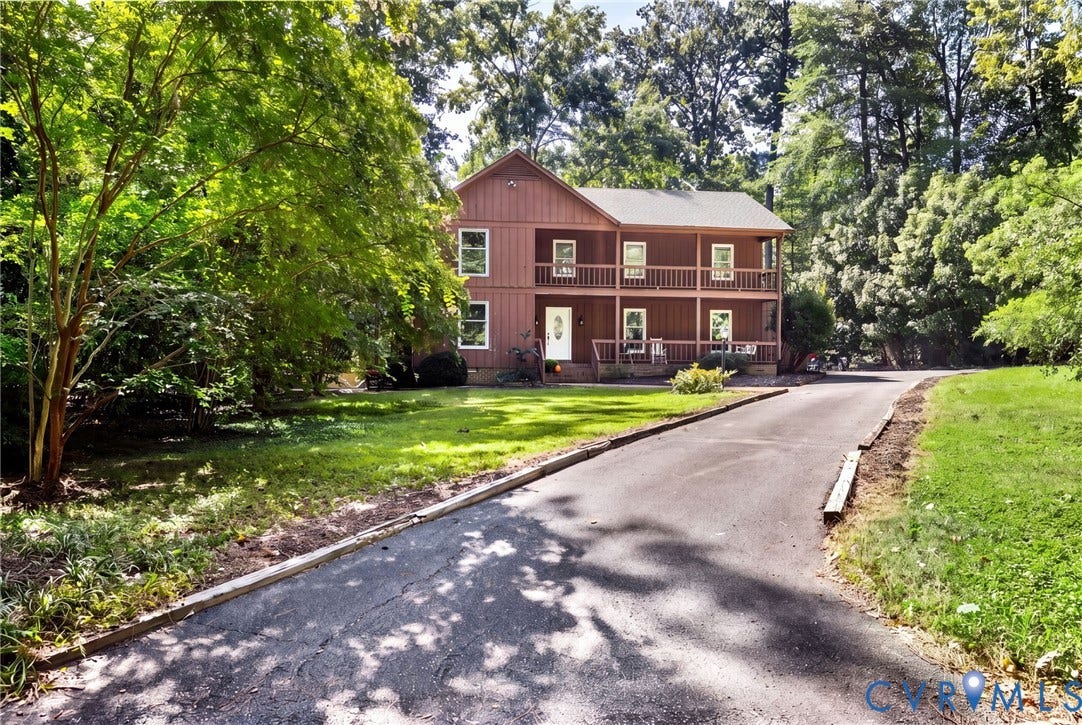 Long paved driveway and large front yard.