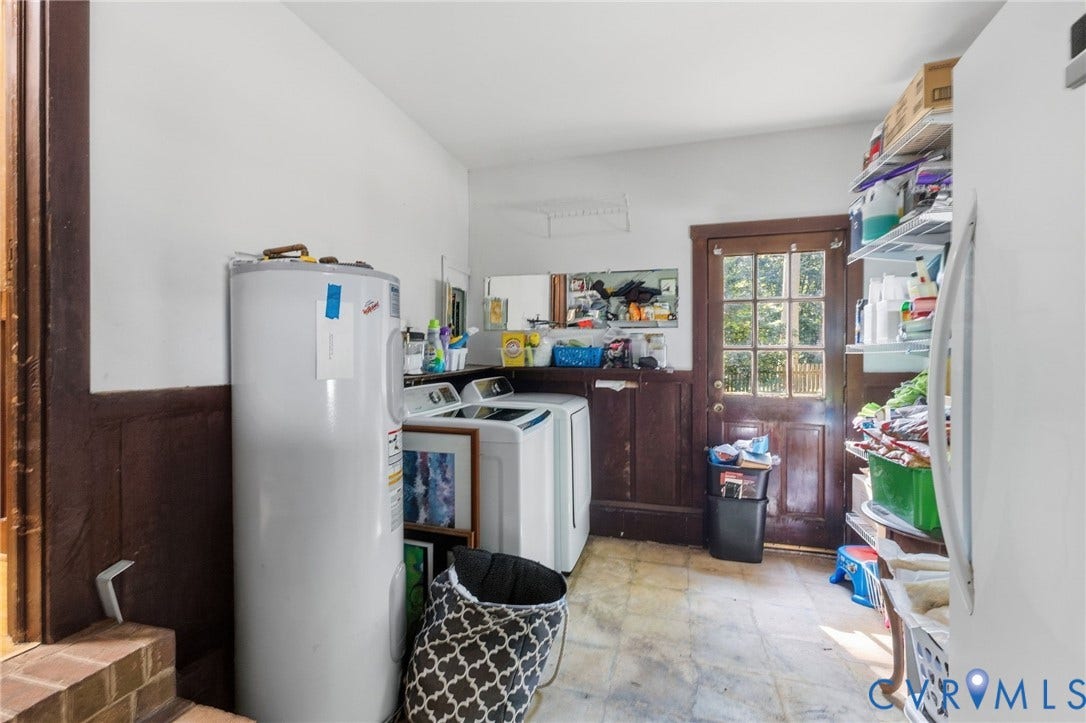 Large utility room with two exist doors to the back and side of the home.