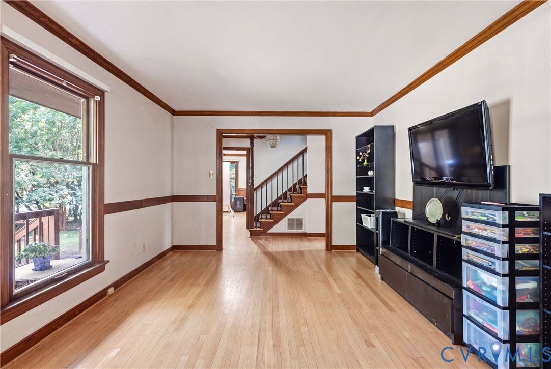 Hardwood flooring, white walls, and wood trim