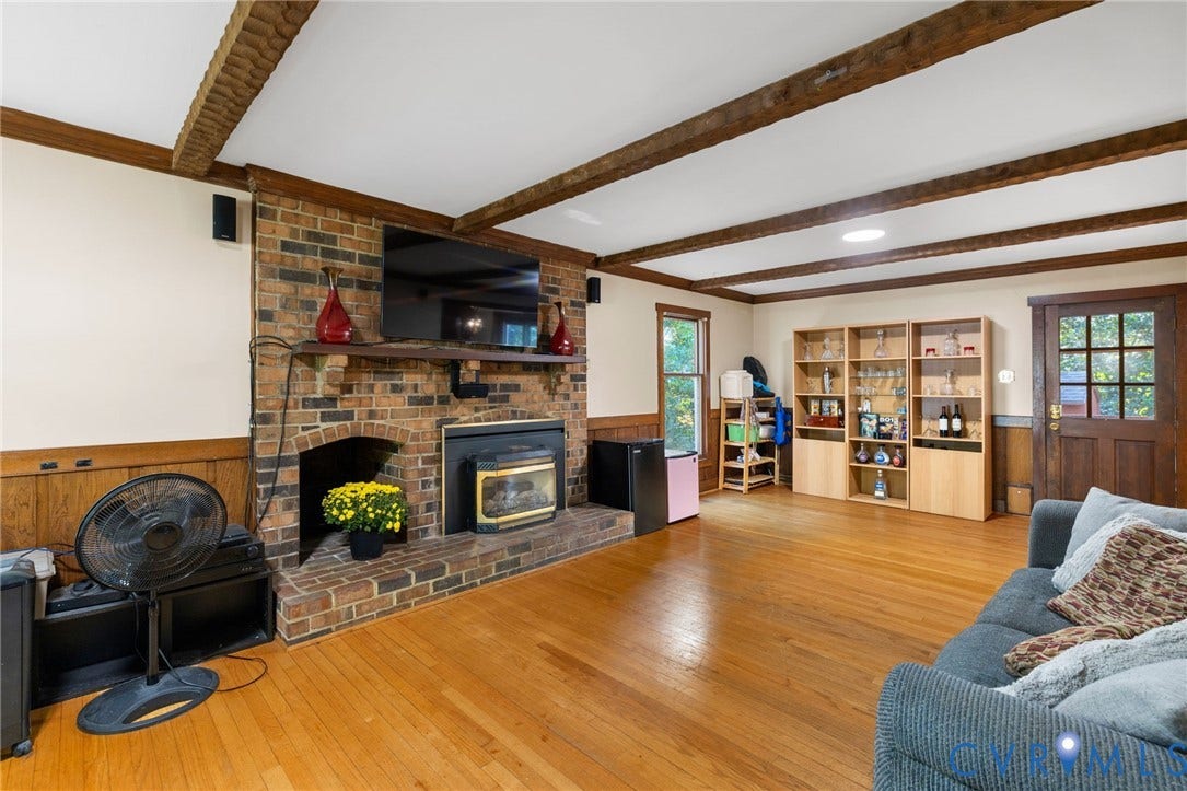 Brick fireplace with gas logs. Access door leads to a great screen porch.