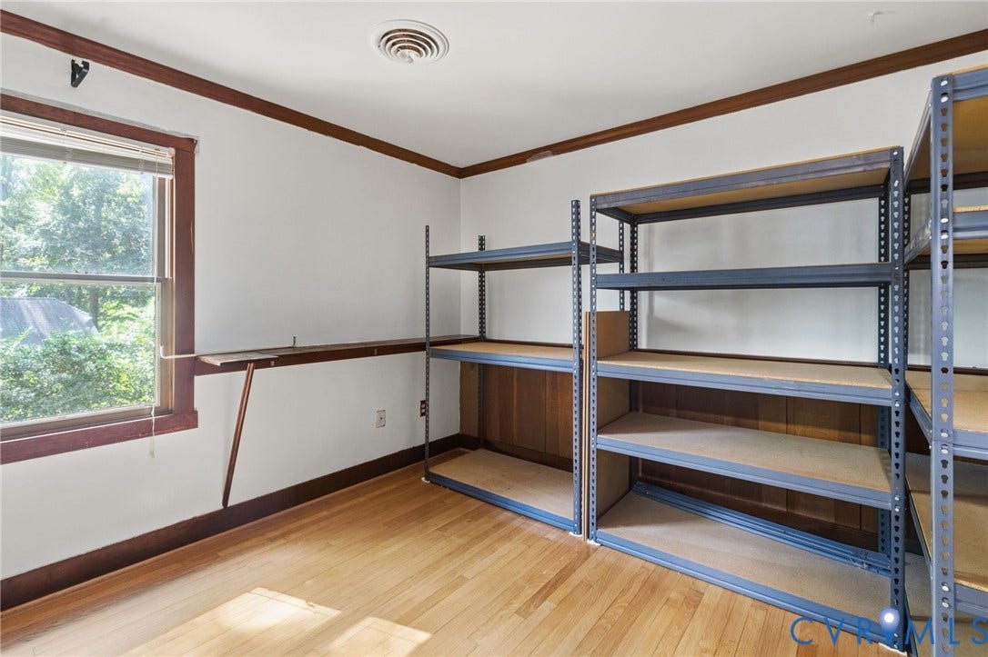 Fourth bedroom has hardwood floor and crown moulding.