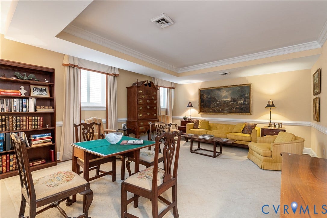 5621 Cary Street Road, #U4, Wilton, Richmond, VA 23226 Tray ceiling with crown molding, custom built-in wooden shelving, and wall chair rail trim