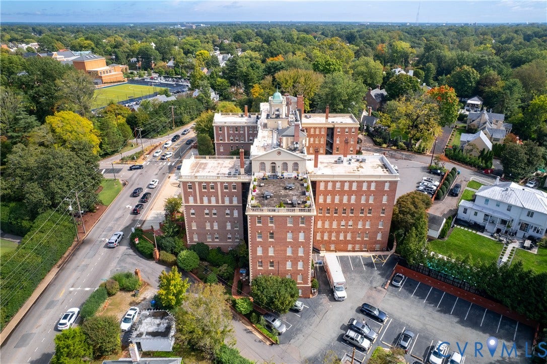 5621 Cary Street Road, #U4, Wilton, Richmond, VA 23226 Multi-story brick exterior featuring a cupola, a rooftop terrace, and a paved parking lot
