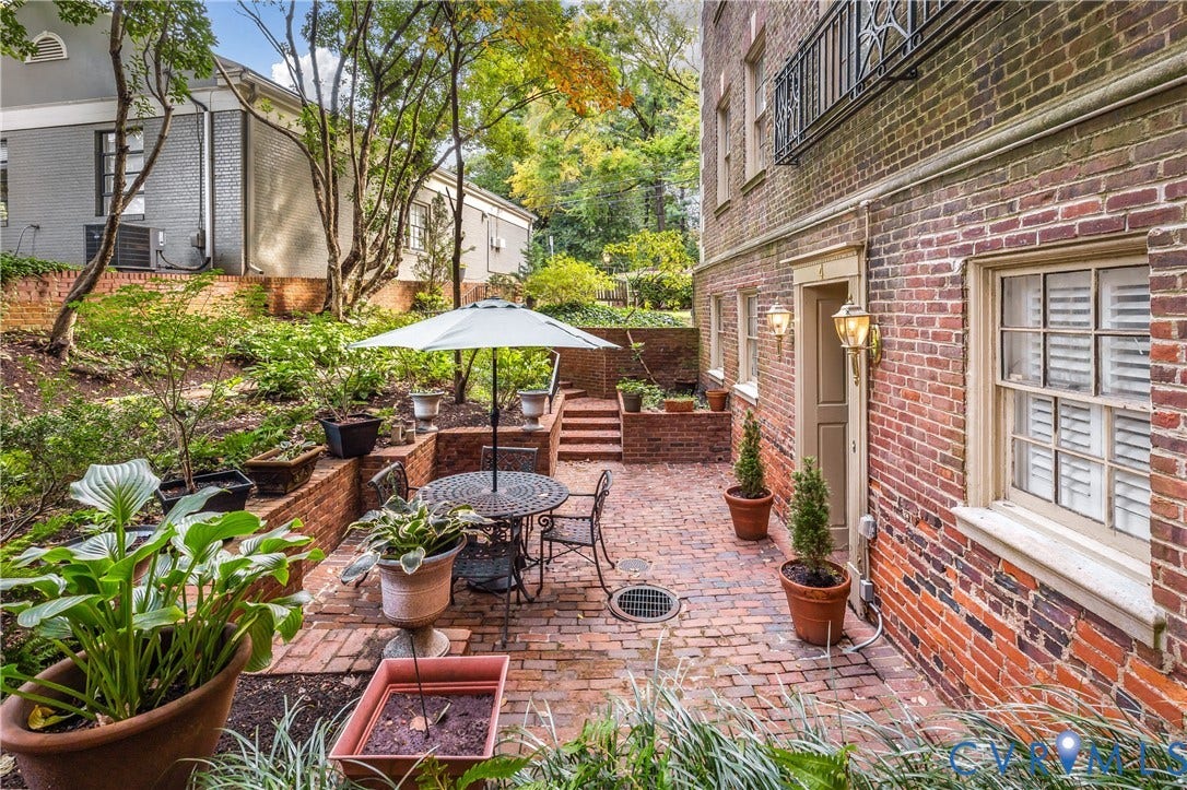5621 Cary Street Road, #U4, Wilton, Richmond, VA 23226 Brick exterior patio featuring multi-level retaining walls, integrated brick steps, and wall-mounted exterior lighting