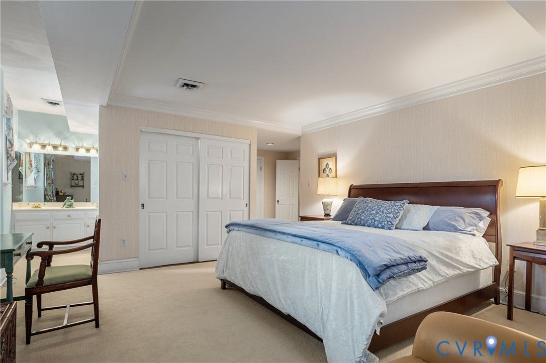 5621 Cary Street Road, #U4, Wilton, Richmond, VA 23226 Neutral-toned wall covering, crown molding, double-door closet with recessed panels, and wall-to-wall carpeting