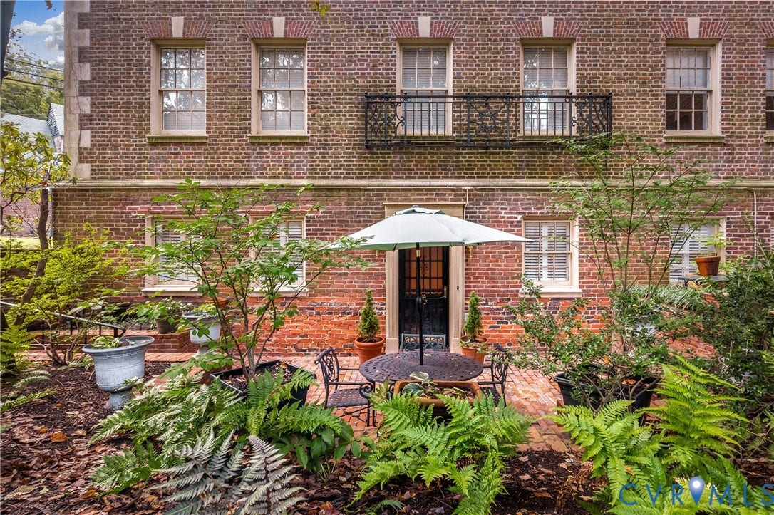 5621 Cary Street Road, #U4, Wilton, Richmond, VA 23226 Brick exterior featuring a wrought iron balcony, multi-pane windows, and a brick patio