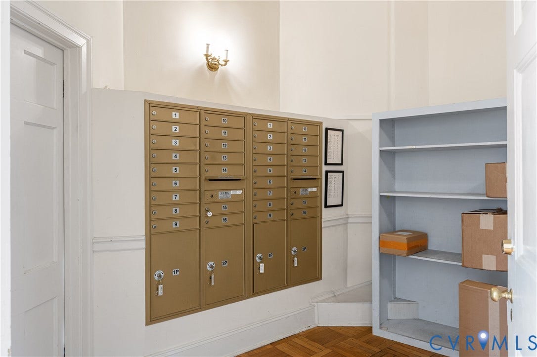 5621 Cary Street Road, #U4, Wilton, Richmond, VA 23226 Mailroom area featuring metallic postal lockers, built-in shelving, and wood-finish parquet flooring