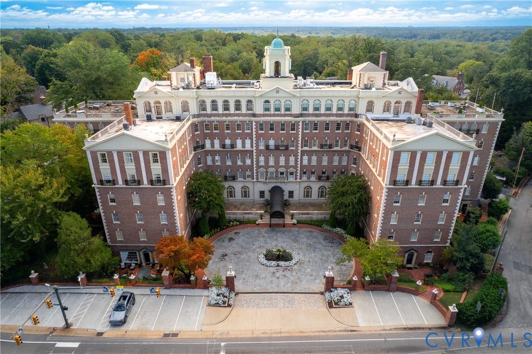 5621 Cary Street Road, #U4, Wilton, Richmond, VA 23226 Multi-story brick exterior featuring a central cupola, decorative pilasters, arched windows, and a circular stone-paved motor court