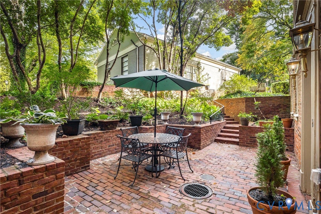 5621 Cary Street Road, #U4, Wilton, Richmond, VA 23226 Terraced brick patio featuring multi-level retaining walls, integrated brick staircase, and wall-mounted exterior lanterns