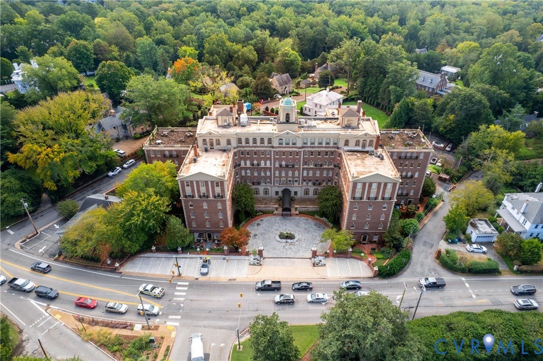 5621 Cary Street Road, #U4, Wilton, Richmond, VA 23226 Multi-story brick building with a central cupola, formal stone-paved motor court, and surrounding mature wooded grounds