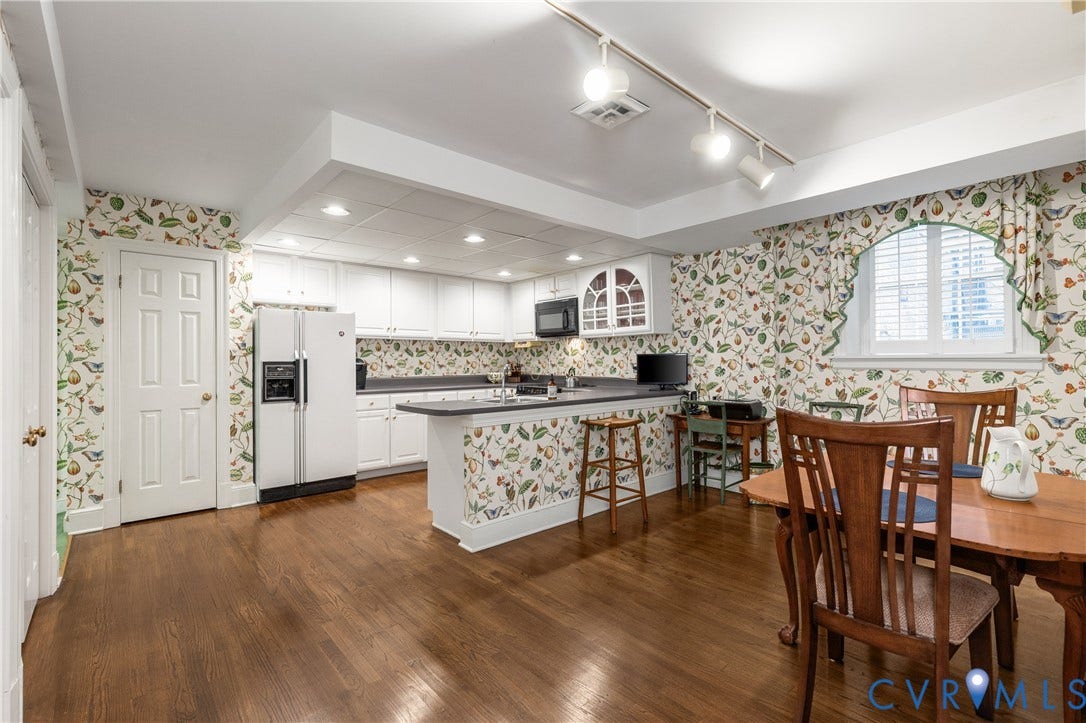 5621 Cary Street Road, #U4, Wilton, Richmond, VA 23226 Kitchen featuring white cabinetry, solid-surface countertops, wood-finish flooring, an arched window, and track lighting
