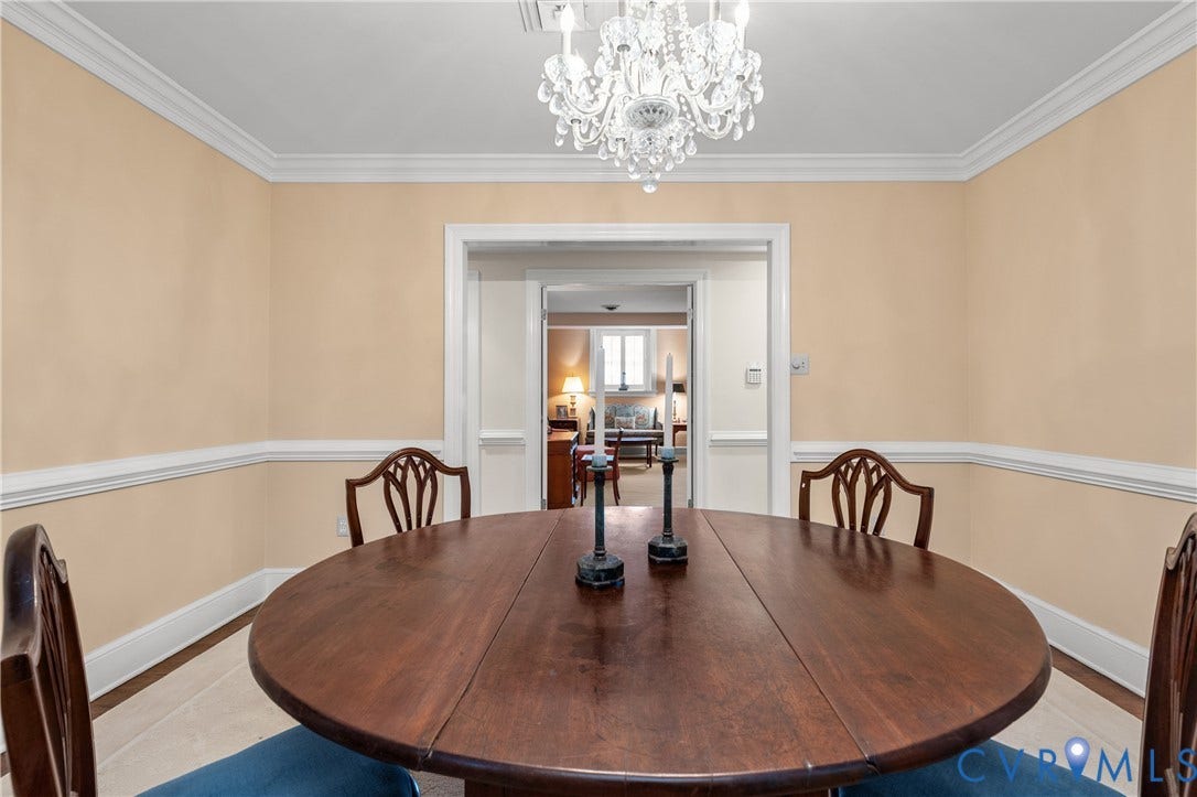 5621 Cary Street Road, #U4, Wilton, Richmond, VA 23226 Dining space featuring a multi-tiered crystal chandelier, crown molding, and chair rail wainscoting