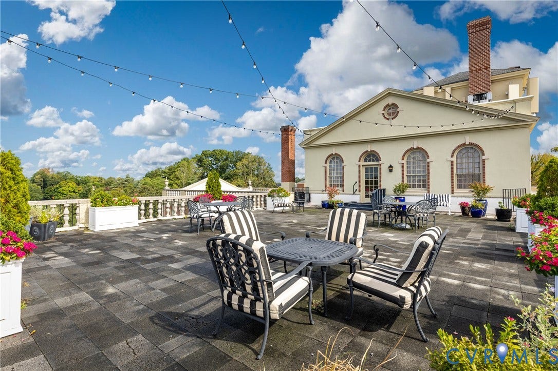 5621 Cary Street Road, #U4, Wilton, Richmond, VA 23226 Expansive rooftop terrace featuring stone paver flooring, a classic stone balustrade, two brick chimneys, and overhead string lighting