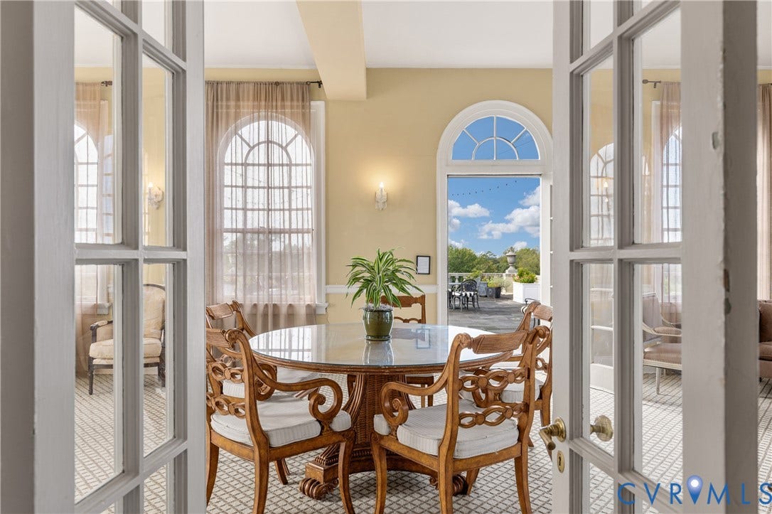 5621 Cary Street Road, #U4, Wilton, Richmond, VA 23226 Sunroom featuring arched windows, tile flooring with a geometric pattern, wall-mounted sconce lighting, and an arched glass-paned door opening to an exterior terrace