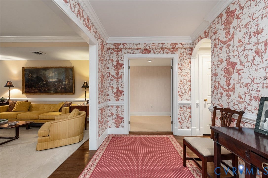 5621 Cary Street Road, #U4, Wilton, Richmond, VA 23226 Foyer featuring patterned wall coverings, chair rail molding, crown molding, arched entryways, and wood-finish flooring