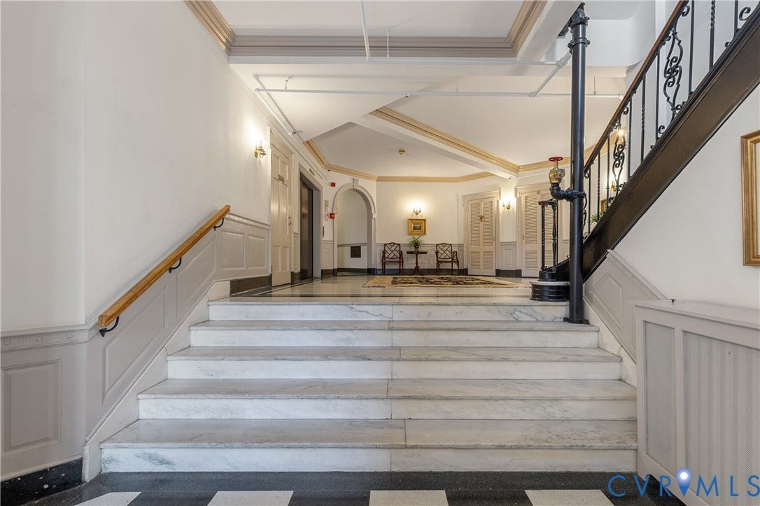 5621 Cary Street Road, #U4, Wilton, Richmond, VA 23226 Foyer featuring stone stairs, a wrought-iron railing with a wood handrail, wainscoting, a vaulted ceiling, and checkerboard-pattern flooring
