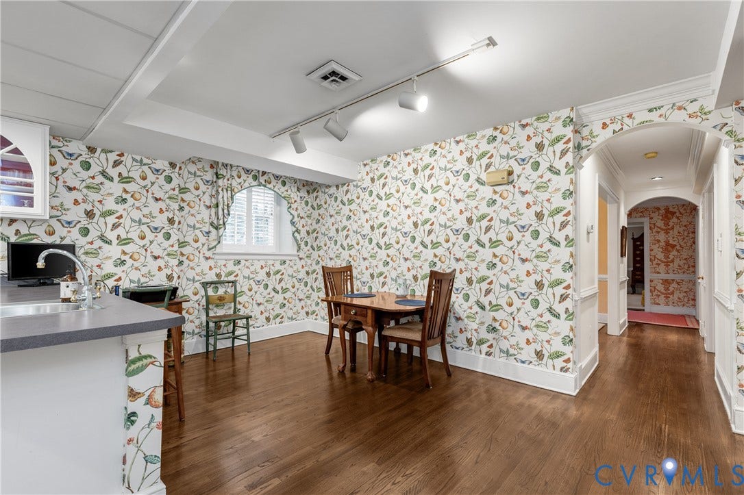 5621 Cary Street Road, #U4, Wilton, Richmond, VA 23226 Wood-finish flooring, archway architectural detail, track lighting, and a kitchen peninsula with an integrated sink