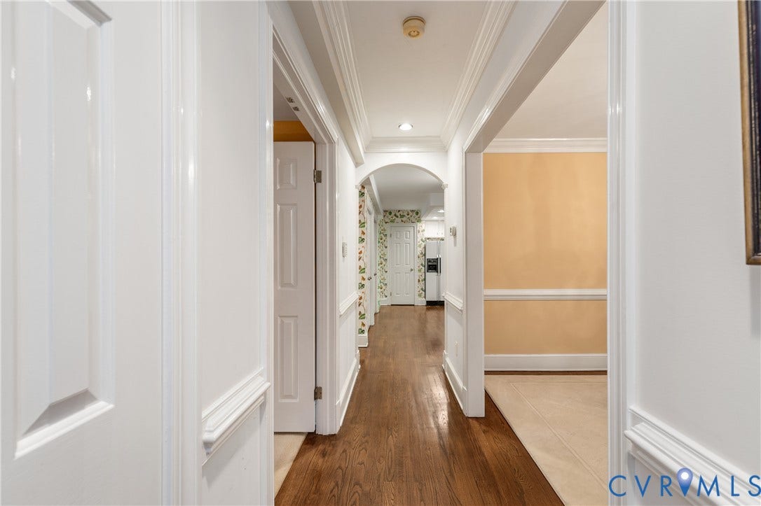 5621 Cary Street Road, #U4, Wilton, Richmond, VA 23226 Hallway featuring wood-finish flooring, crown molding, chair rail trim, recessed lighting, and a decorative arched entryway