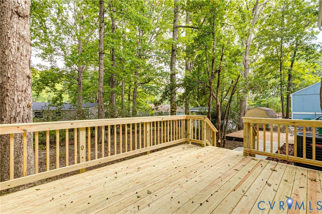 Expansive outdoor wood deck with natural wood railing and balusters