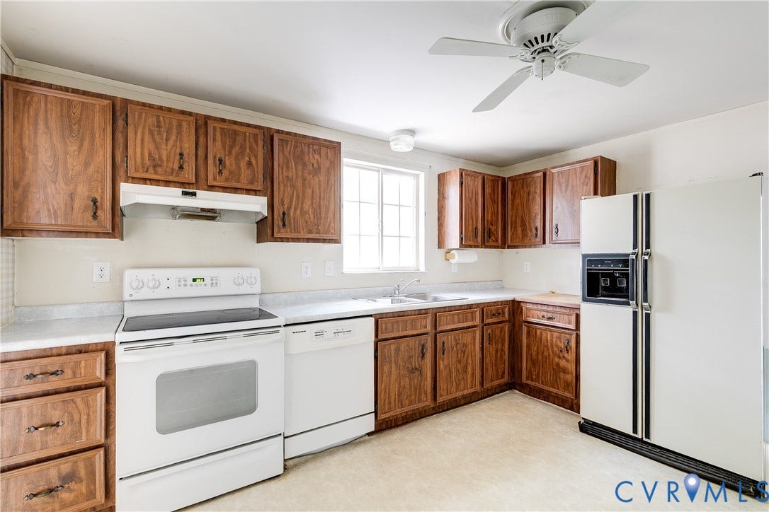 Kitchen featuring wood-finish cabinetry, white countertops, white range, white dishwasher, and a ceiling fan