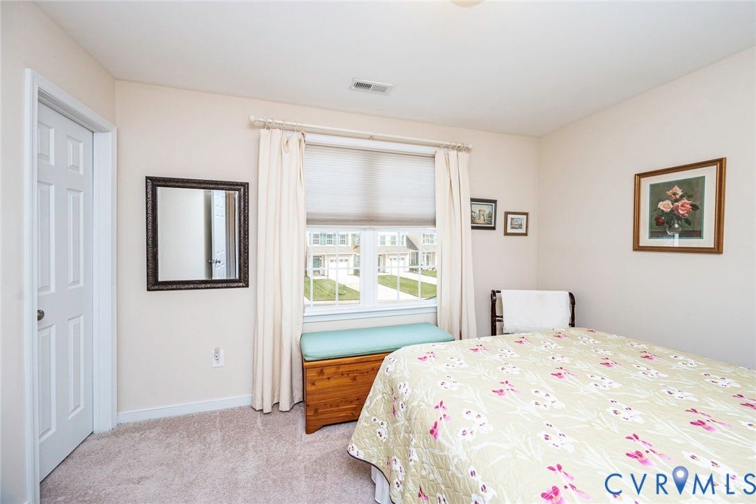 Secondary bedroom with carpet and walk-in closet - great for storage