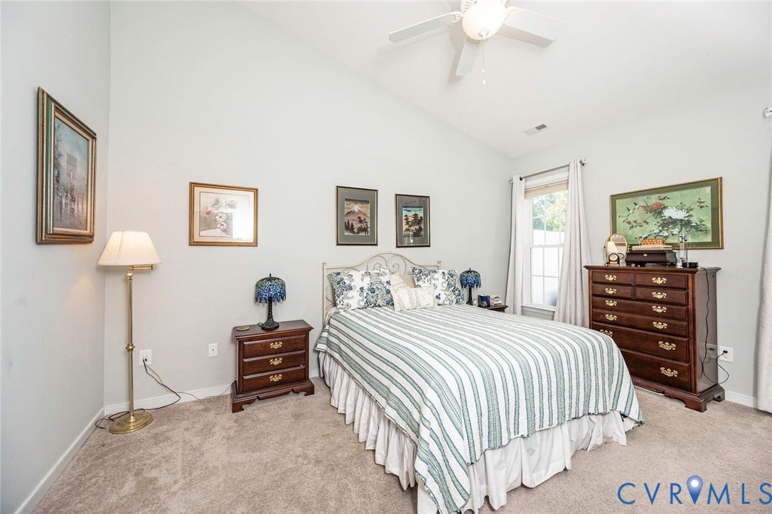 Primary bedroom with vaulted ceiling