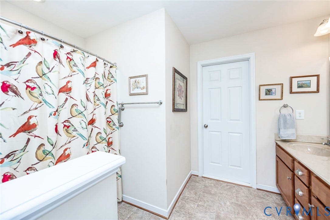 Secondary upstairs full bathroom with access to floored walk-in attic