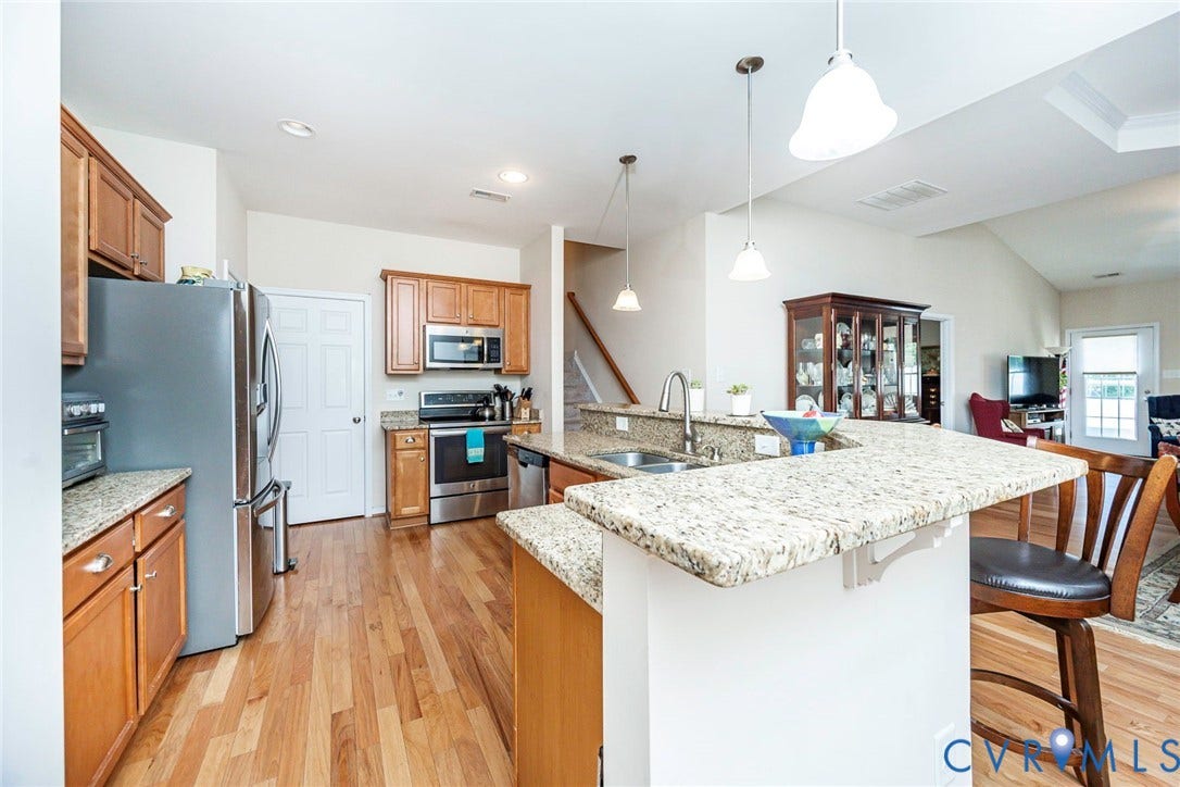 Expansive island and bar countertop open to the main living area