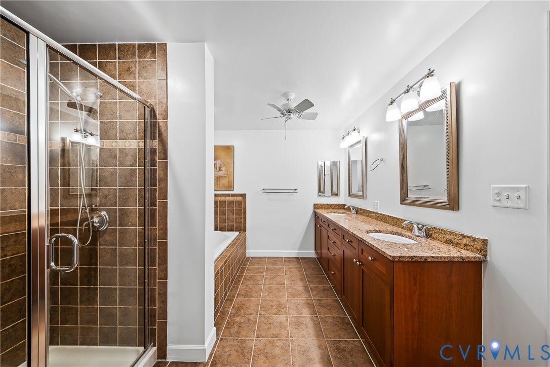 4820 Old Main Street, #503, Sky Line Condo, Richmond, VA 23231 Walk-in shower with glass enclosure, tiled walls, and built-in bathtub with tiled surround