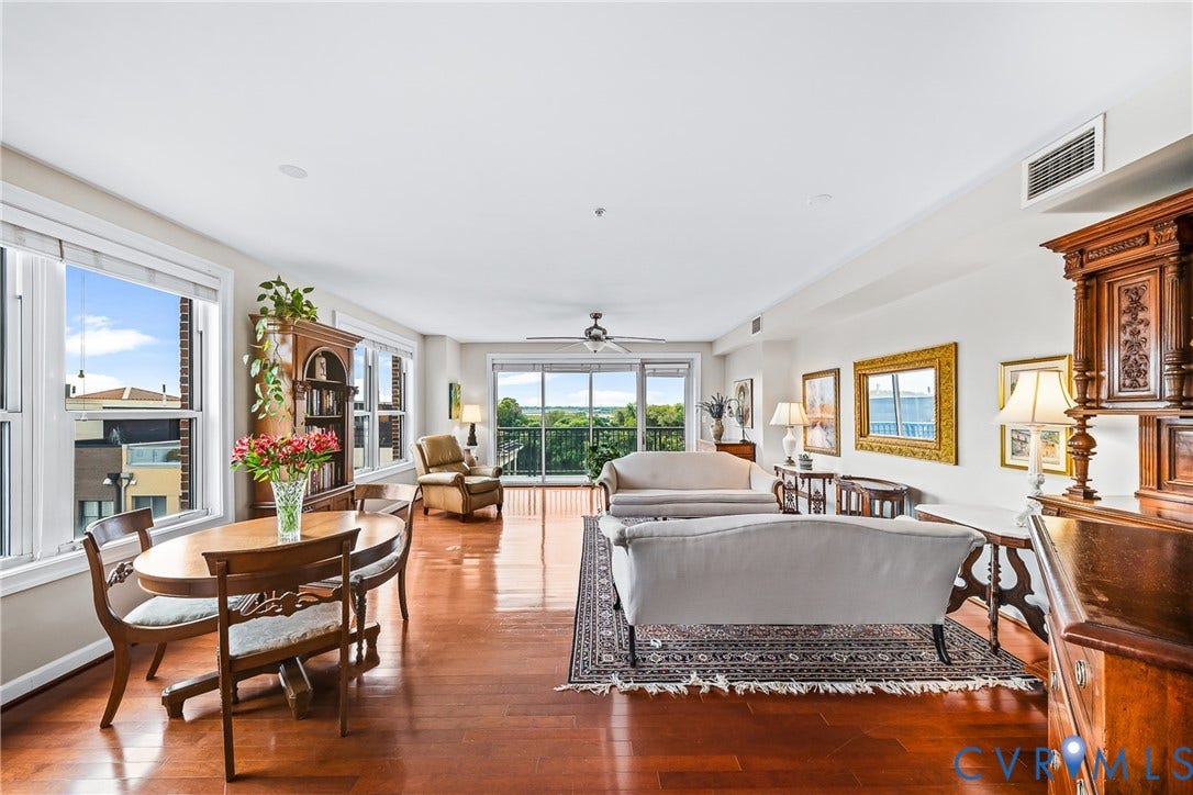 4820 Old Main Street, #503, Sky Line Condo, Richmond, VA 23231 Expansive living area with hardwood flooring, multiple windows, and sliding glass doors leading to a private balcony