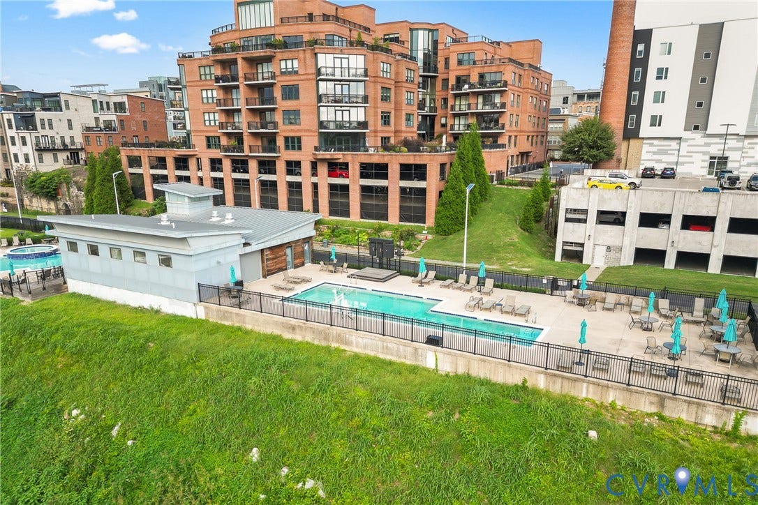 4820 Old Main Street, #503, Sky Line Condo, Richmond, VA 23231 Rectangular outdoor pool with fountains, adjacent hot tub, and surrounding lounge area