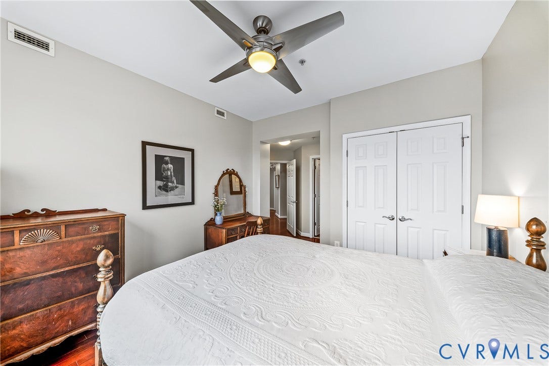 4820 Old Main Street, #503, Sky Line Condo, Richmond, VA 23231 Rich wood-finish flooring, a ceiling fan with integrated lighting, and white paneled doors