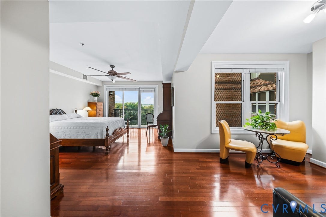 4820 Old Main Street, #503, Sky Line Condo, Richmond, VA 23231 Hardwood flooring throughout, ceiling fan, crown molding, double-paned window, and a sliding glass door leading to a private balcony