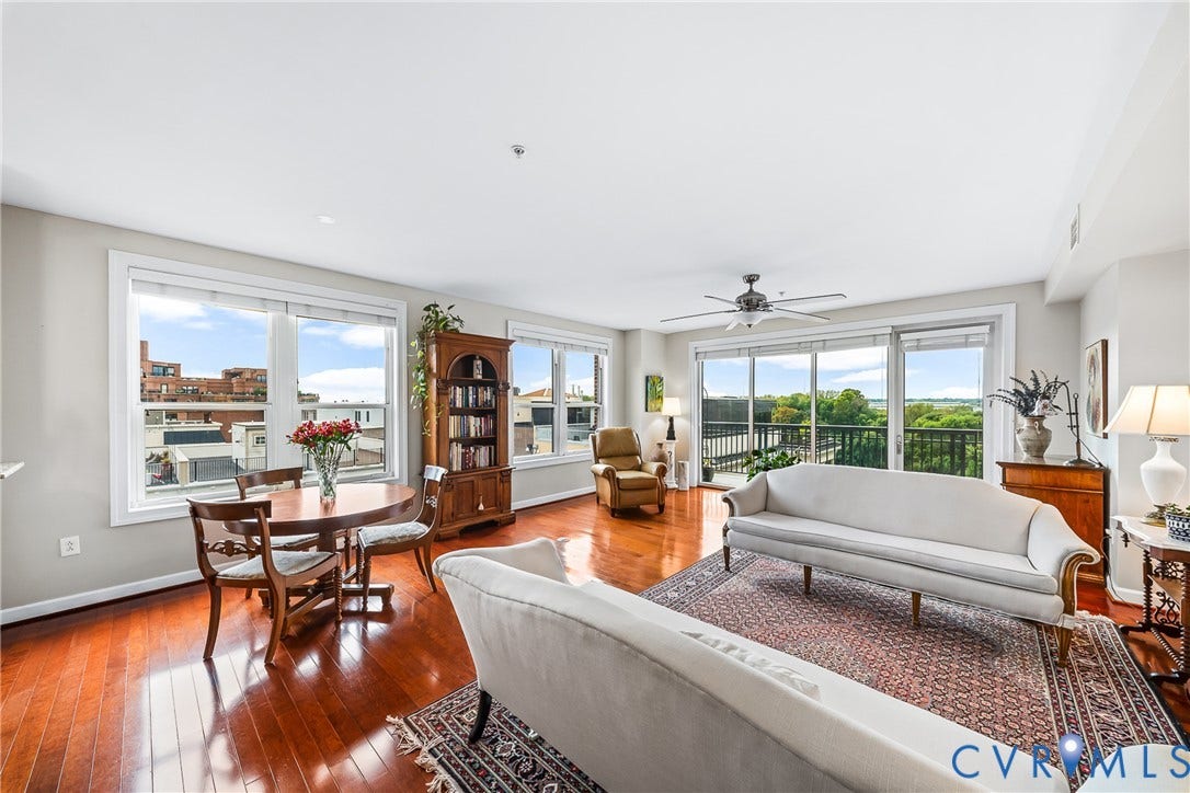 4820 Old Main Street, #503, Sky Line Condo, Richmond, VA 23231 Hardwood flooring throughout, multiple large windows, sliding glass doors to a balcony, and an overhead ceiling fan